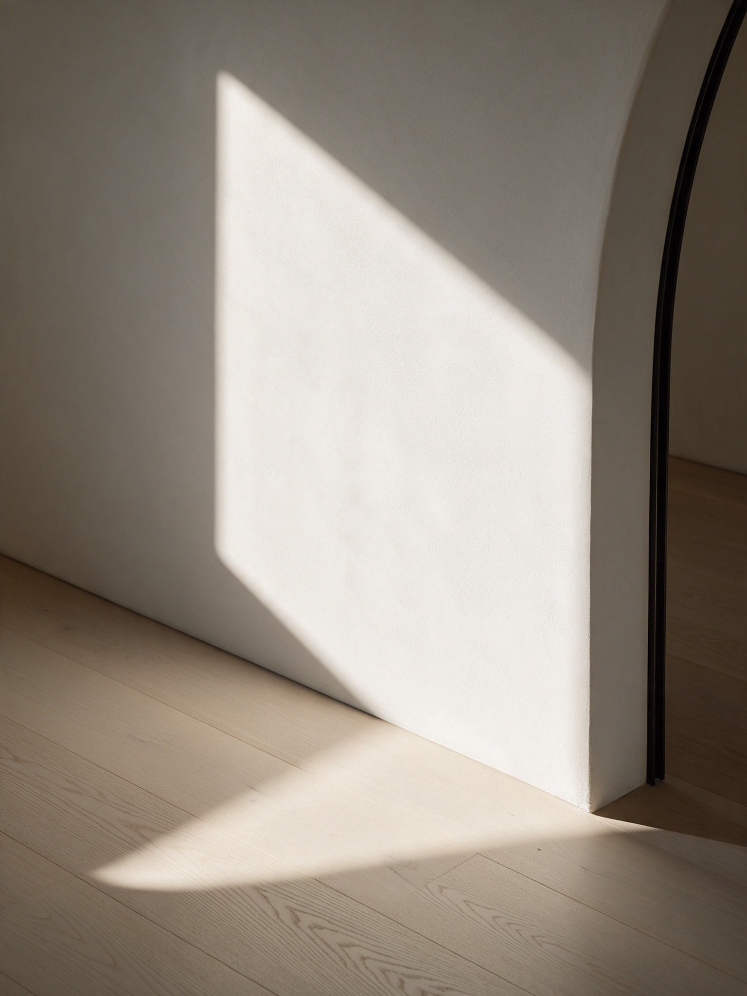 Morning light across plaster and oak